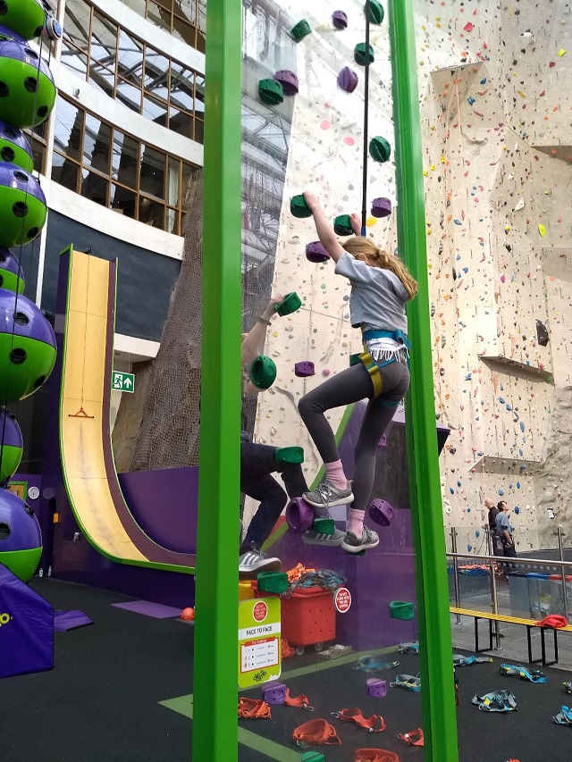 Going Face to Face at Clip 'n Climb, EICA: Ratho, with the Vertical Drop Slide and the Climbing Arena in the background