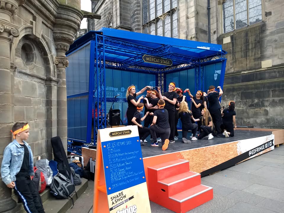 Youth group previewing their act on Royal Mile street theatre stage 